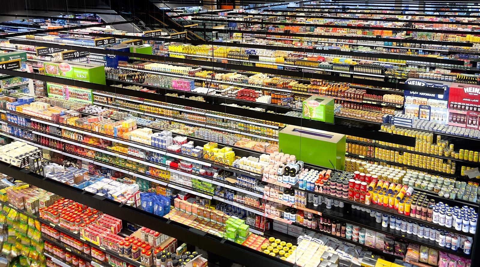 Supermarket aisle stocked with branded beverages and snacks